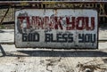 Weathered sign in the street proclaims Ã¢â¬ÅThank You, God Bless YouÃ¢â¬Â in Batangas, the Philippines.